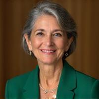 Headshot of Dr. Anya Sharma, a woman in her 50s with a warm, knowing smile, exuding wisdom and calm.